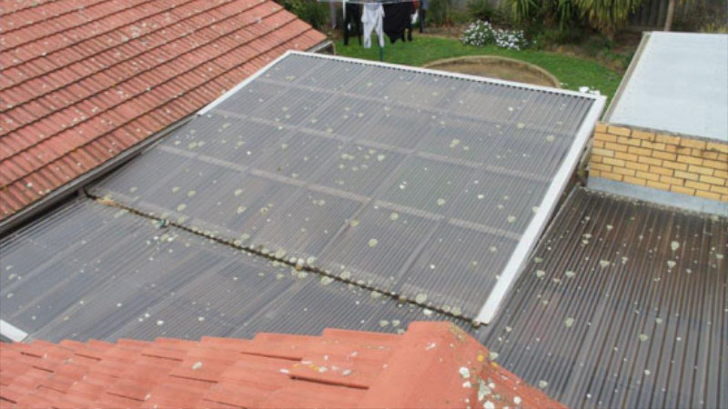 Red cement roof after moss treatment, showing clean surface