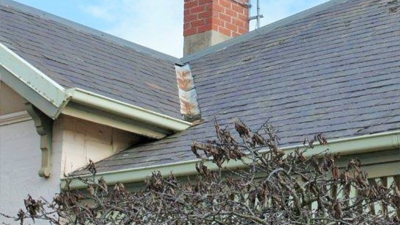 Red cement roof after moss treatment, showing clean surface