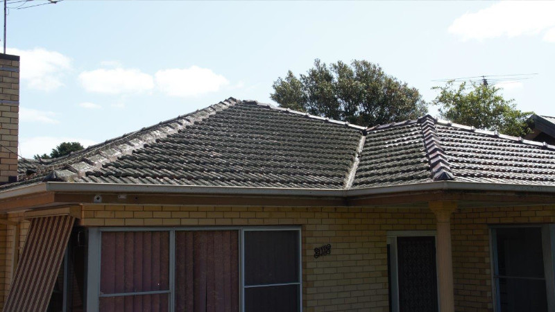 Red cement roof after moss treatment, showing clean surface
